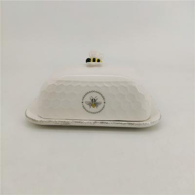 China Sustainable Bee Custom Design Farmhouse Logo Ceramic Honeycomb Embossed Rectangular White Butter Dish With Bee Cover Lid for sale