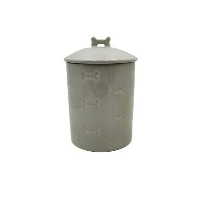 China Sustainable Custom Shaped Bone Pet Cremation Urn Debossed Ceramic Pet Ash Urn for sale