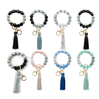 China New Silicone Key Chain Gift High Quality Key Chain Silicone Bead Bracelet Key Ring For Women Letter Tassel Bracelet for sale