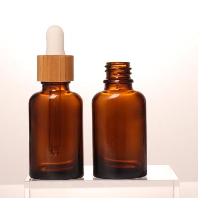 China Personal Skin Care Packaging Unique Style 20ml Amber Glass Packaging Bamboo Cover Drop Cap Essential Oil Bottle For Cosmetics for sale