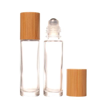 China Personal Skin Care Packaging Beautiful Style 10ml Metal Ball Roller Transparent Lip Oil Roll On Bottle With Bamboo Lids For Wholesale for sale