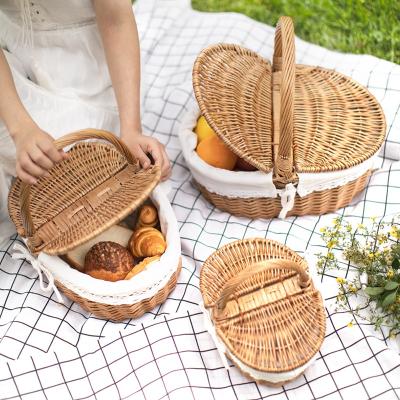 China Summer Sustainable Portable Vintage Unique Food Storage Baskets Round Picnic Wicker Basket With Handle for sale