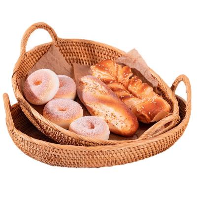 China Sustainable Rattan Bread Basket Round Handwoven Tea Tray With Handle Suitable For Home Dinner for sale