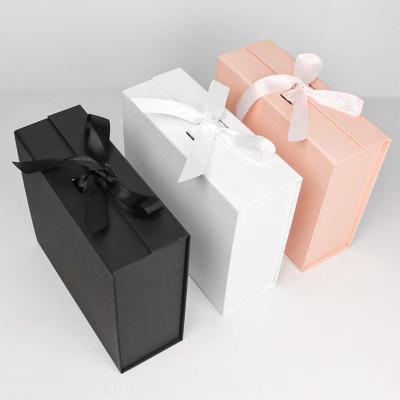 China Recyclable Custom Black Paper Cardboard Magnetic Foldable Gift Box Packaging With Ribbon for sale