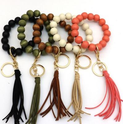 China 2021 fashion good quality charm wood bead elastic line bracelet with tassel with key ring Keychains hangle for sale