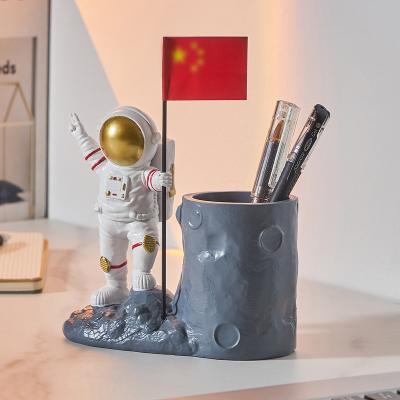 China Modern Resin Decoration Flag Astronaut Pen Holder Makeup Brush Storage Home Ornaments for sale