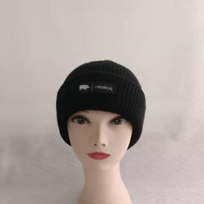 China Customized COMMON size logo badge rubber acrylic beanie adult winter knitted cold cap cuff hat for sale