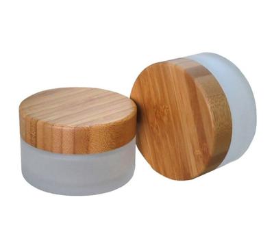 China Fancy 10g 20g 30g 50g personal care frosted glass cream jar wooden lid, bamboo glass cosmetic sample jar container for sale