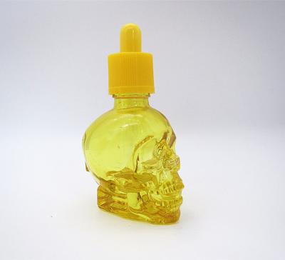 China Eliquid ejuice ecig oil crystal skull shape 30ml perfume glass yellow bottle with child proof yellow cap for sale