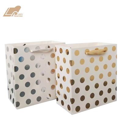 China Recycled Materials Tanning Round Dot Paper Gift Bag With Ribbon Handle Tote Bag for sale