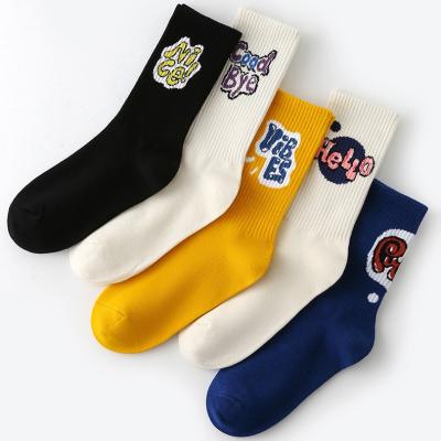 China Novelty Anti-Fault Art Letter Design Jacquard Spandex Combed Cotton Socks With Logo For Unisex for sale