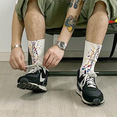 China Anti-foul white black graffiti splatter paint quality combed unisex cotton sports crew socks for sale