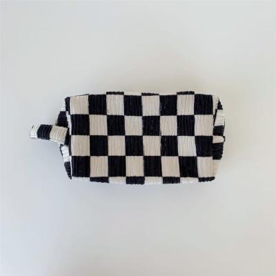 China 2022 high quality checkerboard checkerboard makeup bag large capacity storage bag black and white portable vintage pleated plaid cow pattern for sale