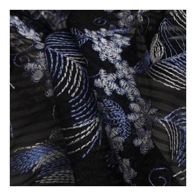 China Elastic fancy loose tulle lace fabric with embroidery for women dress good quality and price for sale