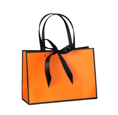 China Gold Border Recyclable Matte Black And White Luxury Perfume Paper Bag Custom Tote Bag for sale