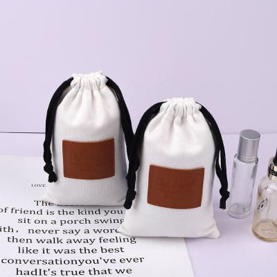 China Custom Cotton Safety Label Canvas Brush Drawstring Perfume Leather Packaging Bag Soft Jewelry Pouch for sale