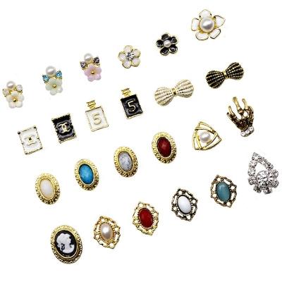 China Shiny Wholesale Price Metal Nail Accessories Rhinrhinos Butterfly Flowers Metal Nail Art for sale