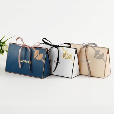 China Recyclable Engraved and Logo Embossed Gold Foil Custom Printed White High Quality Paper Gift Bag White High Quality Paper Bag Folding Trapezoidal Trinket Bag for sale