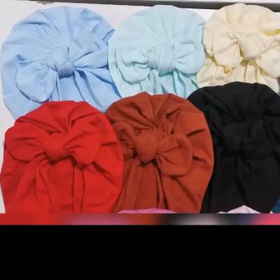 China Wholesale Large Image Solid Color Bow Baby Turban Hats Sweater Fall And Winter Indian Beanie Hats For Baby Toddlers Kids for sale