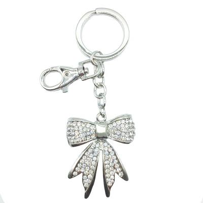 China 2021 Cute Hot Selling Rhinestone Purse Key Chain Birthday Graduation Keepsake Bowknot Charm Zinc Alloy Pendant For Gift for sale