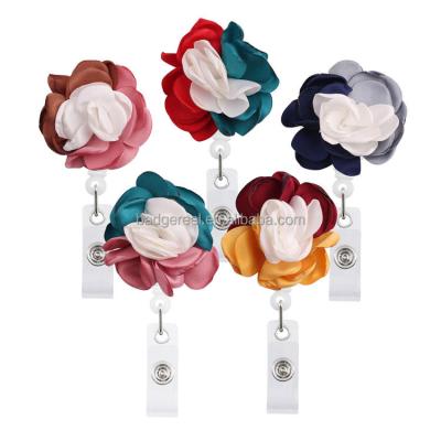 China Desktop Burning Edge Mounted Retractable Flower Badge Reel Yo-Yo Rotation for Doctors Card Nurses Teachers Students ID for sale