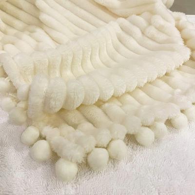 China Anti-Static Microfiber Ball Tassel Cover Up Comfortable Solid Flannel Fleece Jacquard Luxury Blanket With Pompom Tassel for sale