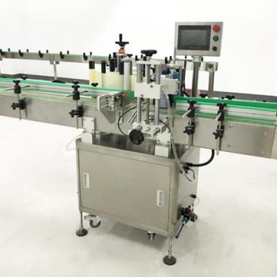 China Automatic Food China Sticker Placing Labeling Machine For Round Bottles for sale