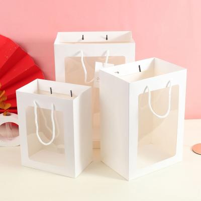 China Creative Wholesale Recyclable Flower Paper Bag Bouquet Waterproof Handbag With Clear PVC Window for sale