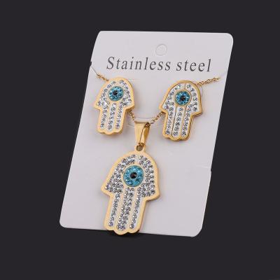 China Ethnic Stainless Steel Hamsa Hand Pave Set Diamond Pendant Blue Eye Charm CZ Crystal Necklace Pendant Earing Charm Jewelry Set Women for sale