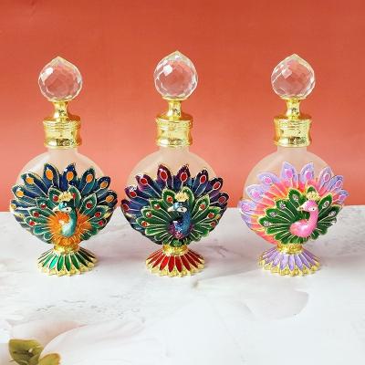 China Color Cosmetic Middle East Zinc Alloy Open Peacock Enamel Dubai Style Caliber Perfume Essential Oil Glass Bottle for sale