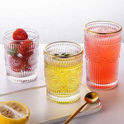 China Disposable Custom Clear Gold Rimmed Water Drinking Whiskey Stemless Sunflower Embossed Glass Tumbler for sale