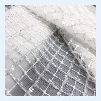 China Viable Embroidery White Wedding Dress Tulle Sequin Wedding Dress Heavy Beaded African Lace Fabric 5 Yards MOQ for sale