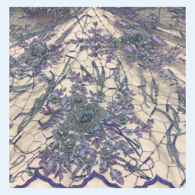 China Viable handmade fringe beaded lace fabric wholesale beaded sequin lace fabric for evening dress for sale