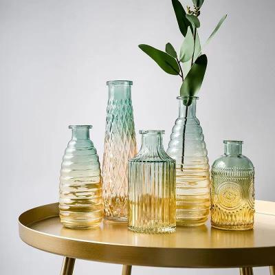 China New modern embossed transparent glass vases small mouth glass bottle vase for sale