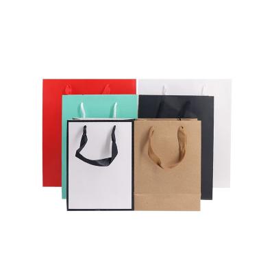 China New Handmade Universal Kraft Paper Bags Kids Clothing Shopping Paper Bags And Recyclable Sticker Boxes for sale