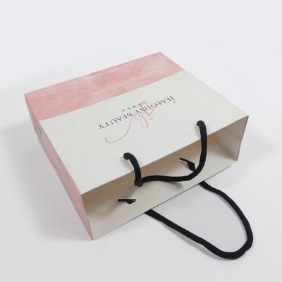 China Offset Printing Paper Gift Packaging Bags Luxury Cosmetic Clothes Gift Carry Bags for sale