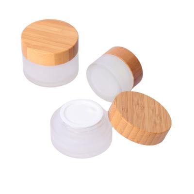 China Hot Selling Low Price Cosmetic Face Cream Container 20ml 30ml 50ml 100ml Clear Glass Jar With Bamboo Lid for sale