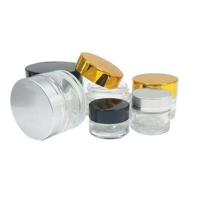 China Cosmetic Factory hot selling clear cosmetic glass container candle jar honey glass jar with black lids for sale