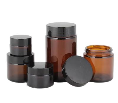 China Cosmetic Factory hot selling 5ml 10ml 20ml 30ml 50ml 60ml 100ml amber  glass jar cosmetic jars with black silver gold lid for sale