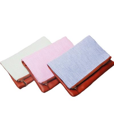 China Fashion USA warehouse cotton seersucker clutch bag with strap detachable bottom patchwork makeup bag leather hand purse DOM-102286 for sale