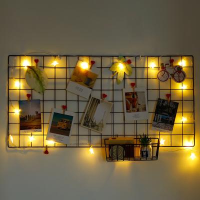 China Eco-Friendly Girl Room Home Decor Wrought Iron Wire Panel Photo Wall Grid Storage Rack Shelf Wall Decoration for sale