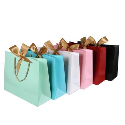 China Gift & Multi Colors Craft Garment Packaging Bags Paper Bag Ribbon Bow Decoration Gift Bag With Custom Logo for sale