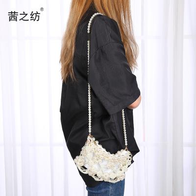 China Fashion factory direct supply new fairy messenger Bag Summer Fashion beaded handmade handbag woven cute bead bag for sale