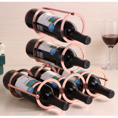 China Single Viable Rose Gold Style Metal Wine Rack 5 Bottle Wine Display Rack for sale