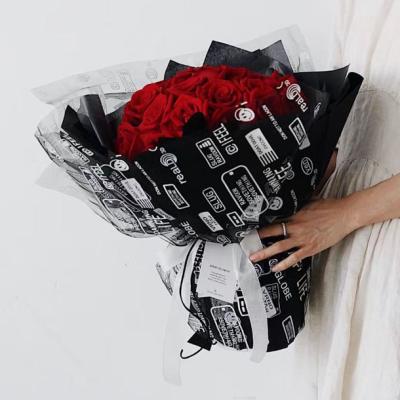 China Smile Flower Waterproof Mesh Wrapping Paper Bouquet Polyester Mesh Rolls Gauze Flower Mesh for sale