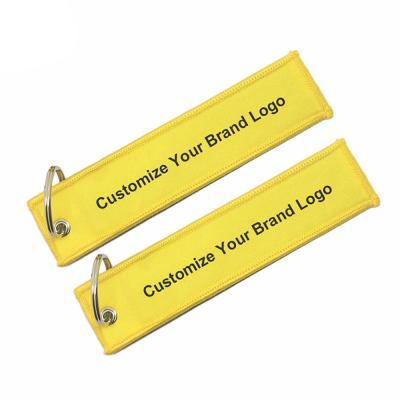 China Wholesale Customized Flight 3-5mm Luggage Tag Label Embroidery Key Chains For Logo Woven Keychains for sale