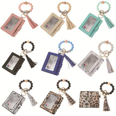 China Fashion PU Bracelet Key Chain Wallet Women Leather Silicone Beaded Bracelet Key Chain Bag Leopard Printed Bracelet Key Ring Holder Card Bag for sale