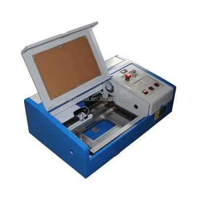 China Water-cooled 40W/50w electric CO2 3020 desktop laser engraving machine for bowlder wood//crystal/paper/PVC/stamp for sale