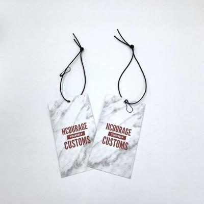 China Custom sustainable fashion T-shirt private label string clothing tag marbel swing tags for sale