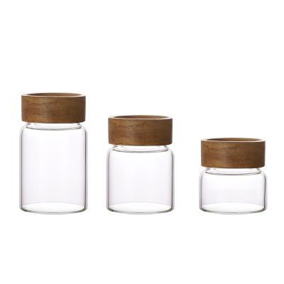 China Small Craftsman 120ml Leak Proof Rubber Seal Lid Borosilicate Glass Storage Container With Screw Acacia Wood Lid for sale